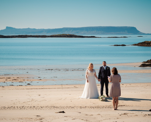 Bride and groom during their wedding ceremony on Caumsdarach beach in Ariasig